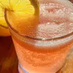 Pink Salt Trick: The Proven 4-Step Morning Habit for Lasting Wellness 9 Glass of pink salt trick drink with lemon slice in warm morning light on wooden table